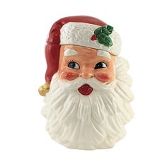 a ceramic santa claus ornament with holly and bell on it's head