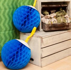 two blue honeycombs sitting on top of a wooden box next to a green wall