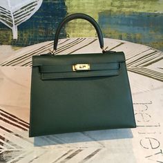 Description HRMS Kelly Green For Women Gold Toned Hardware 10in/25cm Rep 1:1 Size: 25 x 19 x 9 cm / 10 x 7.5 x 3.5 inches (Length x Height x Width) Hermès bags are considered the ultimate luxury item worldwide. Each piece is handcrafted with waitlists that can exceed a year or more. The streamlined and demure Kelly style is always in high demand, it is particularly lovely in this vibrant version with silver hardware. Epsom is textured with a wonderful grainy appearance. Epsom is soft to the hand Kelly 25, Louis Vuitton Shirt, Chanel Shirt, Togo Leather, Birkin 25, Luxury Products, Hermes Bags, Mini Crossbody Bag, Evening Clutch Bag