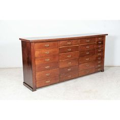 a large wooden dresser sitting on top of a white floor