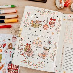 an open planner with christmas decorations on it