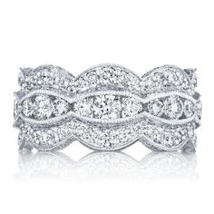 a wedding band with three rows of round diamonds on the top and bottom, set in 18k white gold