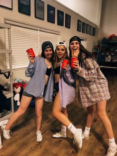 three young women are posing for the camera while holding coffee mugs in their hands