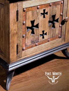 an old wooden cabinet with metal studs on the front and sides, sitting on a hard wood floor