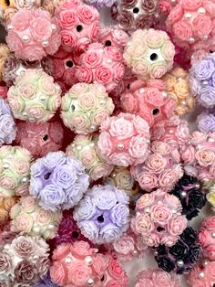 a pile of pink and purple flowers next to each other