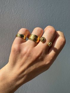 Elevate your style with our exquisite collection of gold stacking rings, exclusively available at Christina Christi Store. Crafted to perfection, this set features a medium-width ring with engraved edges, a mesmerizing evil eye design on the middle ring, and a uniquely stunning ring with two spheres at the edges. Each ring is slightly adjustable for a comfortable fit on any finger. With a diameter of 17mm (0.67'') or US size 7, these rings are versatile for any occasion. Please note that each ri Heirloom Style Stackable Midi Rings With Round Band, Adjustable Gold Plated Stackable Rings Fine Jewelry, Adjustable Gold-plated Stackable Rings In Fine Jewelry Style, Adjustable Gold Plated Stackable Rings, Gold Stackable Midi Rings Fine Jewelry, Gold Stackable Midi Rings, Gold Brass Rings With Round Band, Adjustable Gold Plated Yellow Gold Stackable Rings, Gold Stackable Midi Rings In Recycled Material