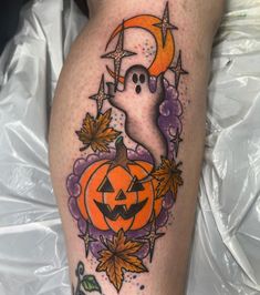 a halloween themed leg with a ghost and pumpkin