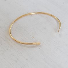 Hammered ends with unadorned metal, stack this cuff with others or celebrate it on its own! 14K Gold-filled Hypoallergenic and Nickel-free Ethically hand-made in the USA. Luxury Hammered Minimalist Bracelets, Luxury Minimalist Hammered Bracelets, Minimalist Yellow Gold Brass Cuff Bracelet, Minimalist Open Band Cuff Bracelet, Minimalist Adjustable Hammered Cuff Bracelet, Minimalist Hammered Cuff Bangle Bracelet, Minimalist Hammered Bangle For Everyday, Handmade Gold Cuff Bracelet For Everyday, Minimalist Hammered Cuff Bracelet As Gift