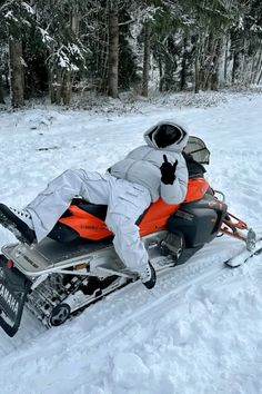 a man riding on the back of a snowmobile