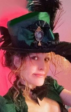 "Victorian/ Belle Epoque/ Steampunk  (or possibly Late Jacobean with the right attire) Ladies Top Hat in sumptuous Hunter Green satin with high quality black gimp trim. Featured in the front is a knife pleated satin ribbon rosette centered by the buyer's choice of antique style Cameo Brooch depicting the Three Graces or Conch Maiden, both with Mughal Style Crystal Dangles* (all the rage during The Empire Period.)Decorating the side of this hat are peacock and goose feathers, topped with a large Steampunk Hats Women, Steampunk Belle, 3 Graces, Top Hat Costume, Edwardian Hat, Steampunk Top, Steampunk Top Hat, Victorian Hats, Steampunk Hat