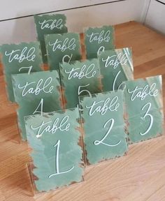 there are many place cards that have been placed on top of the table for guests to sign