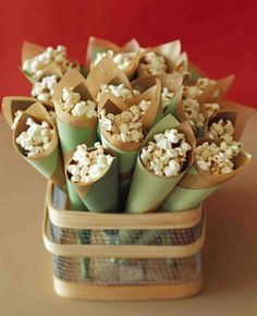 a bunch of food wrapped in paper on top of a wooden table next to a red wall