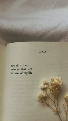 an open book with some flowers on it and the words maza written in cursive writing