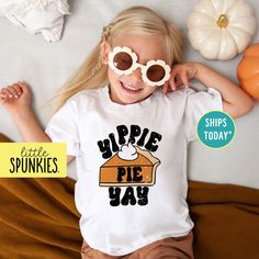 Funny Pumpkin Pie T-Shirt, Kids Thanksgiving Shirt, Yippie Pie Yay Graphic Tee (YIPPIE PIE YAY) PRODUCTION TIME Little Spunkies from the designer/owner of Spunky Pineapple Co https://www.etsy.com/shop/SpunkyPineappleCo   All baby and toddler clothes are 100% designed and printed with water based ink. All orders placed before 12:00 pm EST are shipped out same day (Monday - Friday). Orders received after noon are shipped out the next business day. ONESIES® BRAND  Made from 100% Cotton. We print on Onesies® Brand and do recommend ordering up one size as these run a little small after washing. T-SHIRT Made from 100% Cotton. These run true to size. If you are in between sizes we suggest sizing up. RAGLAN Made from 52% Cotton / 48% Polyester. These run true to size. If you are in between sizes w Playful Pre-shrunk T-shirt For Fall, Thanksgiving Shirts For Kids, Kids Thanksgiving, Funny Pumpkins, Thanksgiving Kids, Thanksgiving Shirt, Kids Graphic Tees, Baby And Toddler, Thanksgiving Shirts