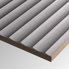 a close up view of an aluminum cladding with wood slats on the bottom