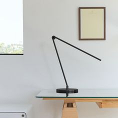 a desk lamp sitting on top of a glass table next to a radiator