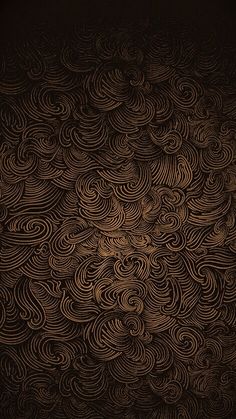 an intricately designed wallpaper with wavy lines and swirls in gold on black