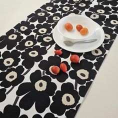 a white plate topped with small pieces of fruit on top of a black and white table cloth