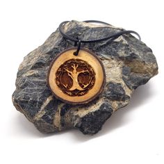 This wooden pendant is engraved with our original Celtic tree of life design. In Celtic culture, the tree of life is believed to be a symbol of wisdom, harmony and the interwoven nature of existence. In Celtic legends, trees guard sacred wells, and Druids were known to hold their sacred rites in groves of oak trees. *This wooden pendant is created with locally sourced wood and treated with mineral oil to preserve and hydrate the wood. *Comes with a 20-inch waxed cord with a 2-inch chain extender Nature-inspired Tree Of Life Pendant Necklace, Spiritual Natural Wood Jewelry Gift, Spiritual Natural Wood Necklaces As Gift, Spiritual Natural Wood Necklaces For Gifts, Natural Wood Spiritual Necklaces For Gifts, Engraved Natural Wood Necklace As Gift, Engraved Natural Wood Necklace For Gift, Wooden Pendant Necklace, Sacred Well