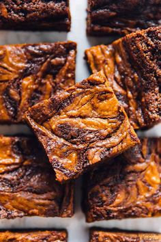 some brownies that are sitting on a white plate and have been cut into squares