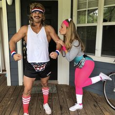 a man and woman dressed in costumes standing on a porch