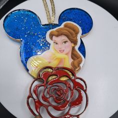 a disney mouse ornament with a red rose