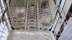 an empty dishwasher with two glasses in it