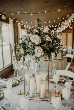 a table with candles and flowers on it