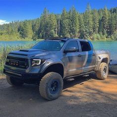 a truck parked next to a body of water