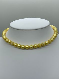 Gold Freshwater Pearl Necklace. This hand knotted strand features 47 Gold Freshwater Pearls AAA High Luster round 8.4-9.4 mm yellow overtones finished with a 8mm polished 14K Yellow Gold Filled bead clasp. This necklace measures 17 1/4 inches in length. I hand knotted this necklace with gold silk thread. These are genuine pearls, they are color enhanced, they are well matched with a few minor surface blemishes. The necklace pictured is the one you will receive, we hand craft our pieces one at a Yellow Pearl Necklaces With Round Beads, Classic Yellow Round Bead Jewelry, Formal Yellow Jewelry With Round Beads, Elegant Yellow Round Bead Necklaces, Elegant Yellow Pearl Necklace For Formal Occasions, Yellow Round Pearl Necklace As A Gift, Yellow Round Pearl Necklace Gift, Yellow Pearl Necklace As A Gift, Classic Yellow Necklaces For Formal Occasions