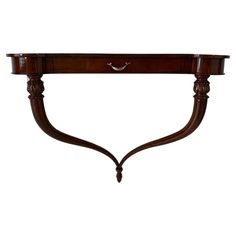 a wooden shelf with two curved legs