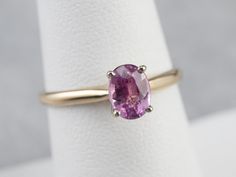 The focal point of this ring is absolutely the bright, rich, glowing pink sapphire set at the center! The simple engagement mounting, with balanced shoulders and high mounted prongs, is the perfect frame for this sweet stone and will sit nicely next to a variety of wedding band styles. Metal: 14K Yellow and White Gold Gem: Pink Sapphire 1.00 Carat Gem Measurements: 5 x 6.5 mm, Oval Ring Size: 7 Marks: "14K" Stamped on the inside band Pink Sapphire Ring With Prong Setting As Gift, Classic Pink Ruby Ring With Accent Stones, Pink Sapphire Solitaire Ring For Formal Occasions, Pink Oval Amethyst Ring With Prong Setting, Classic Pink Solitaire Wedding Ring, Classic Pink Ruby Ring With Prong Setting, Classic Pink Solitaire Ruby Ring, Pink Sapphire Ring In Prong Setting, Classic Pink Sapphire Round Cut Ring