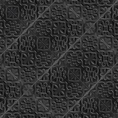 the texture of black leather with decorative designs on it, as well as an abstract pattern