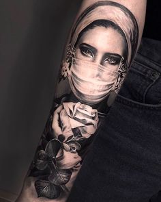 a woman with a veil on her head and roses around her neck is shown in this tattoo