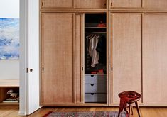 a room with wooden cabinets and a rug on the floor in front of it,