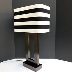 a black and white lamp sitting on top of a table