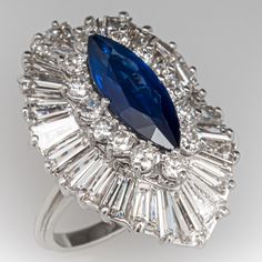 a ring with a blue stone surrounded by crystal stones