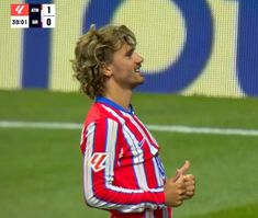 a soccer player is giving the thumbs up sign