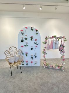 two chairs and a wall with flowers on it