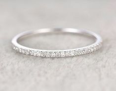 a white gold wedding band with small diamonds