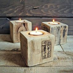 three cement blocks with lit candles in them