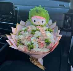 a hello kitty bouquet in the passenger seat of a car