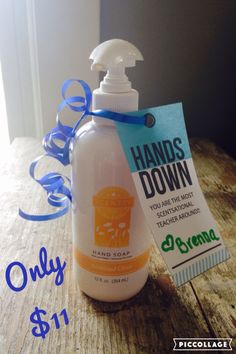 a bottle of hand sanitizer sitting on top of a wooden table next to a blue ribbon