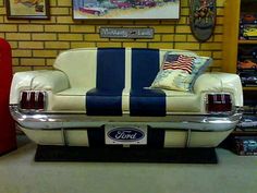 a white and blue couch sitting in front of a brick wall