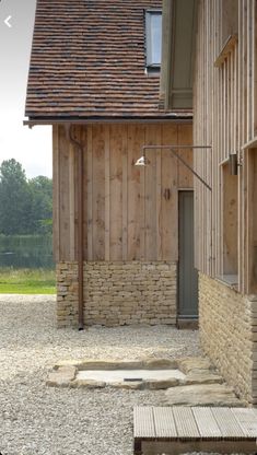 a wooden building sitting next to a stone walkway