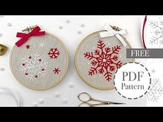 two snowflakes are on the hoop next to some scissors and other crafting supplies