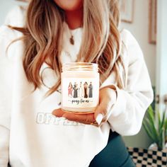 a woman holding a jar of peanut butter