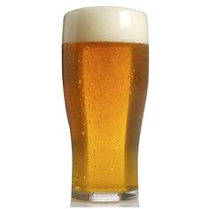 a tall glass filled with beer sitting on top of a table