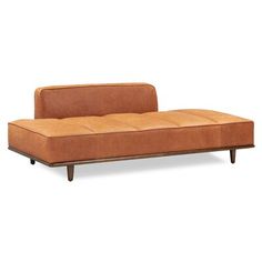 a brown couch sitting on top of a white floor