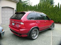 a red car parked in front of a house